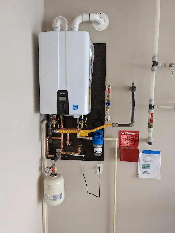 Professional plumber installing copper piping in a Ferris home